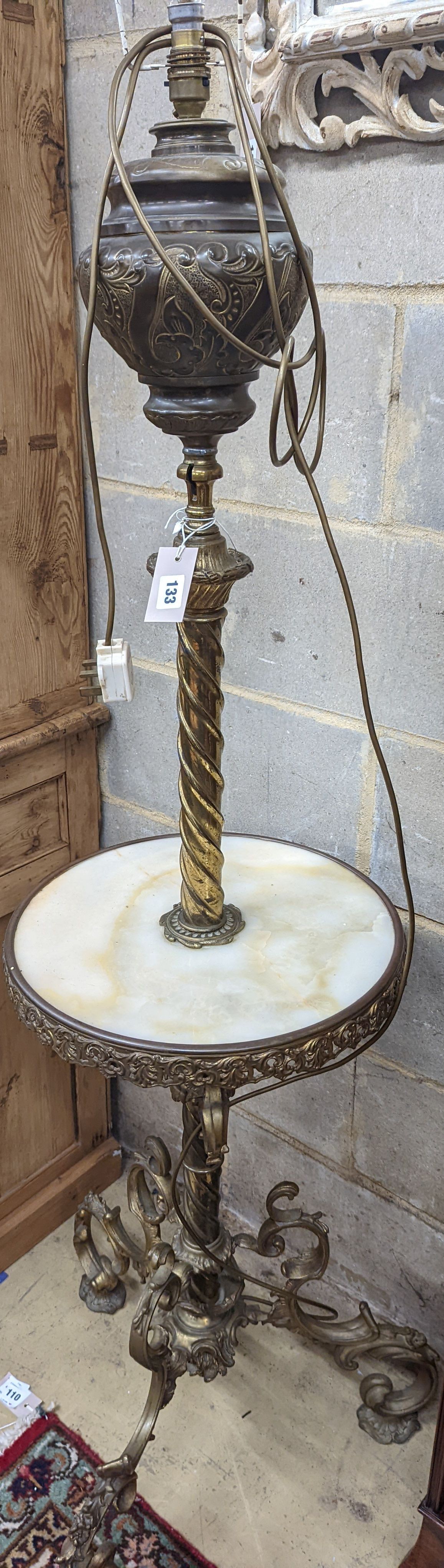 A late Victorian cast brass and onyx oil lamp standard, the column with an alabaster mid tier, raised on an open scrolled tripod base, converted to electricity, height 152cm